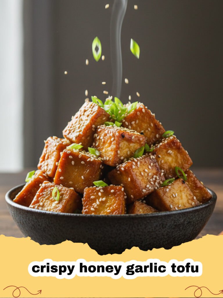 A bowl of crispy honey garlic tofu served over rice with green onions