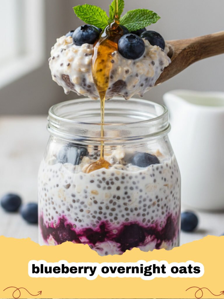 A glass jar filled with creamy blueberry overnight oats topped with fresh blueberries