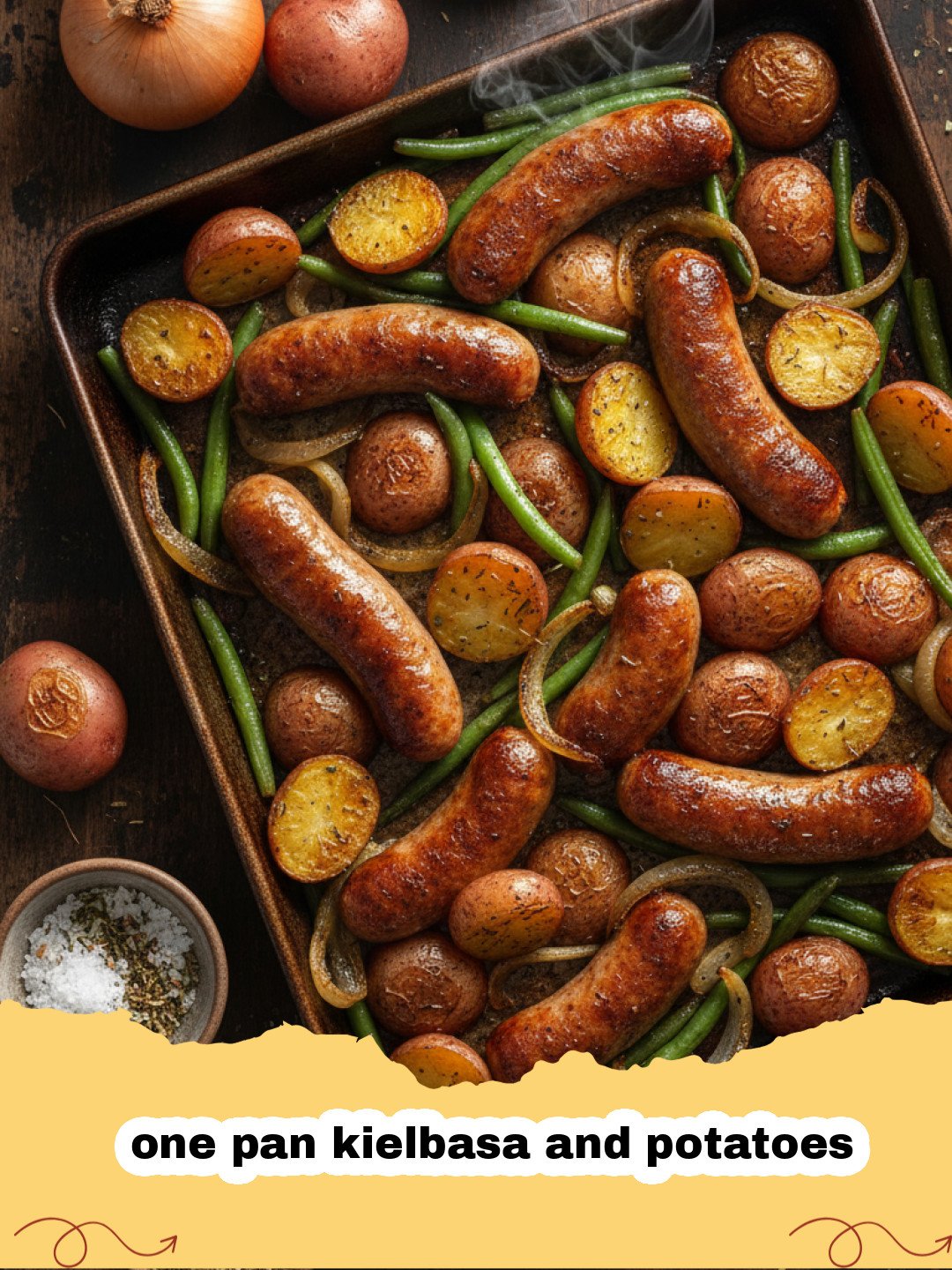 one pan kielbasa and potatoes - A sheet pan filled with roasted kielbasa, crispy potatoes, and colorful peppers.