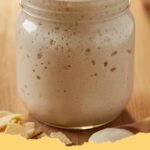 ultimate potato flake sourdough starter - A bubbling, active potato flake sourdough starter in a glass jar, ready for baking.