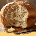 A golden-brown loaf of Cloud Soft Everyday Bread Recipe, sliced, revealing its incredibly airy and tender crumb, resting on a wooden cutting board.
