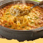 corn casserole recipe - A golden-brown, creamy corn casserole in a white baking dish, garnished with fresh parsley, ready to serve.