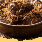 Close-up of a square slice of Decadent German Chocolate Dump Cake on a white plate, showing the gooey coconut-pecan topping and moist chocolate cake layers.