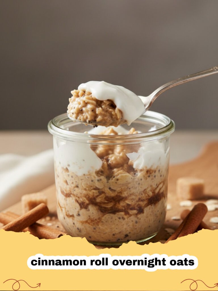 A jar of creamy cinnamon roll overnight oats with a swirl of cream cheese icing on top, garnished with a sprinkle of cinnamon.