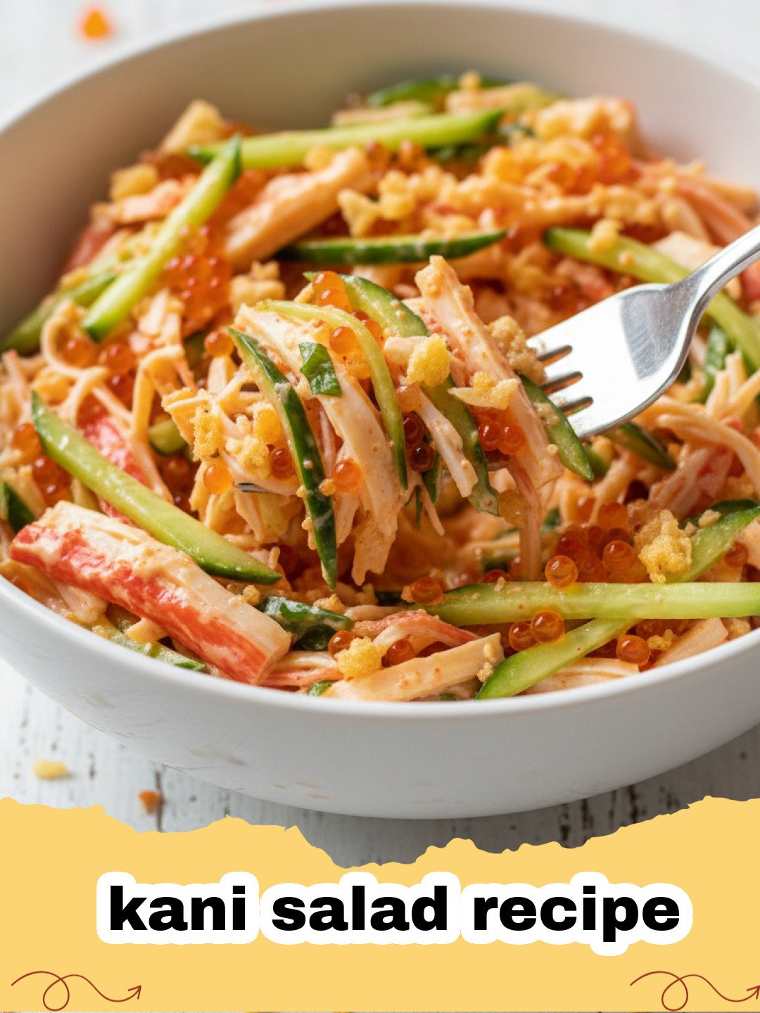 kani salad recipe - Close-up of a vibrant kani salad with shredded imitation crab, cucumber, and mango in a creamy orange dressing, garnished with sesame seeds.