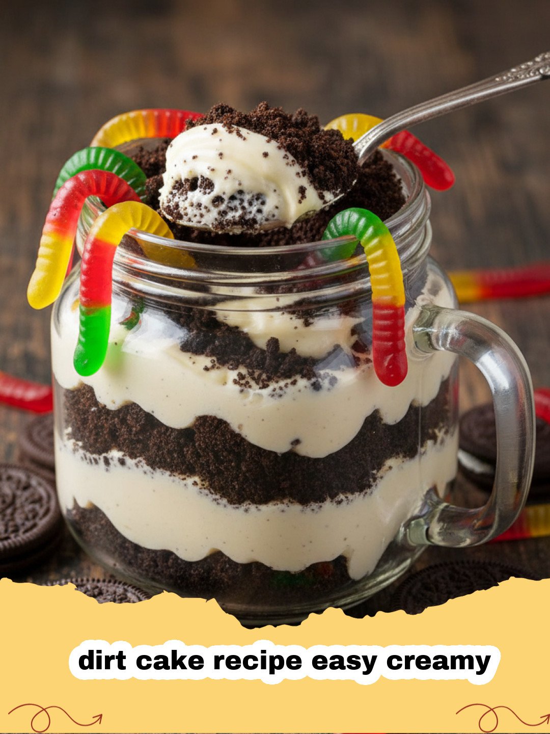 dirt cake recipe easy creamy - Easy creamy dirt cake in a trifle bowl, garnished with gummy worms and mint leaves.