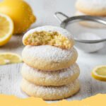Close-up of freshly baked Easy Lemon Meltaway Cookies dusted with powdered sugar and glazed with lemon icing on a white plate.