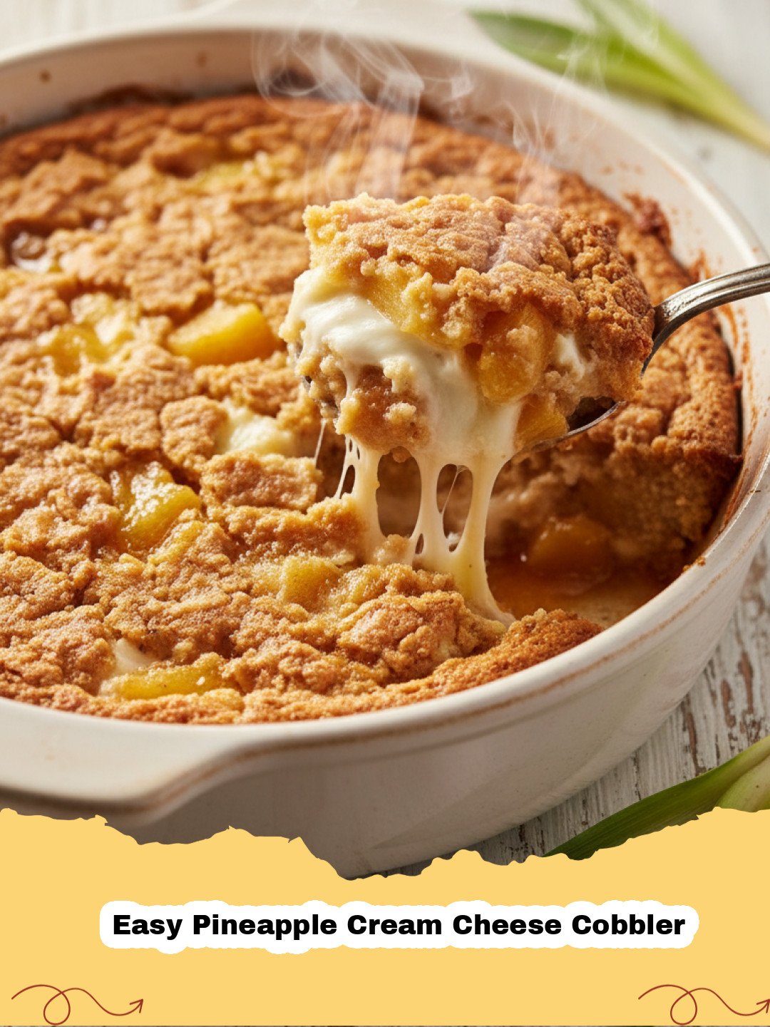 A golden-brown Easy Pineapple Cream Cheese Cobbler fresh from the oven, with a creamy, bubbly pineapple filling peeking through its cake crust. Served in a white baking dish.