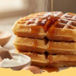 easy waffle recipe without milk - Stack of golden, fluffy easy waffles without milk, topped with fresh berries and powdered sugar.