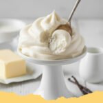 Ermine Frosting Recipe Fluffy Less Sweet - Ermine frosting piped onto a vibrant red velvet cupcake, showcasing its fluffy texture.