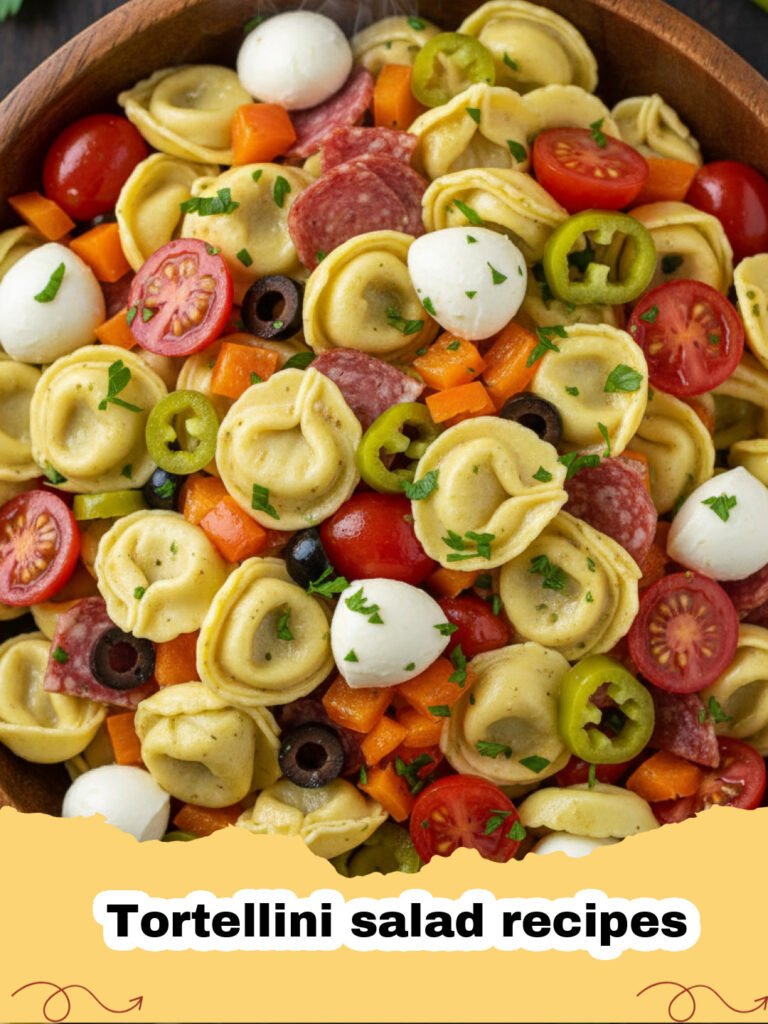 Tortellini salad recipes - A large glass bowl filled with zesty Italian tortellini salad with colorful vegetables and salami.