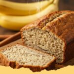 Ultimate Moist Banana Bread Recipe - A perfectly baked, golden-brown loaf of moist banana bread on a wire cooling rack, with a few slices cut, revealing its tender crumb.