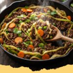 A close-up shot of a hearty Ground Beef and Cabbage Skillet in a cast iron pan, garnished with fresh parsley.