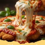 chicken parmesan recipe - Close-up of a golden-brown, crispy chicken parmesan cutlet topped with melted mozzarella and fresh basil, served in a cast iron skillet.