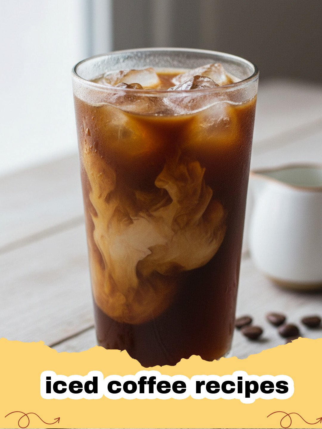 iced coffee recipes - A tall glass of homemade iced coffee with milk, ice, and a straw on a rustic wooden surface.