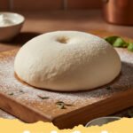 pizza dough recipe - Two golden-brown homemade pizza crusts, one topped with sauce and cheese, the other plain and ready for toppings, on a rustic wooden board.