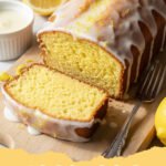 starbucks lemon loaf recipe - A moist, golden-yellow lemon loaf with a thick, white lemon glaze drizzled over the top, sitting on a cooling rack.