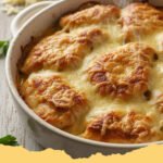 Creamy Melt In Your Mouth Chicken Easy Recipe with parsley garnish, served in a white baking dish.