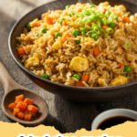 fried rice recipe - A steaming plate of classic easy fried rice with chicken, peas, carrots, and scrambled egg, garnished with green onions.
