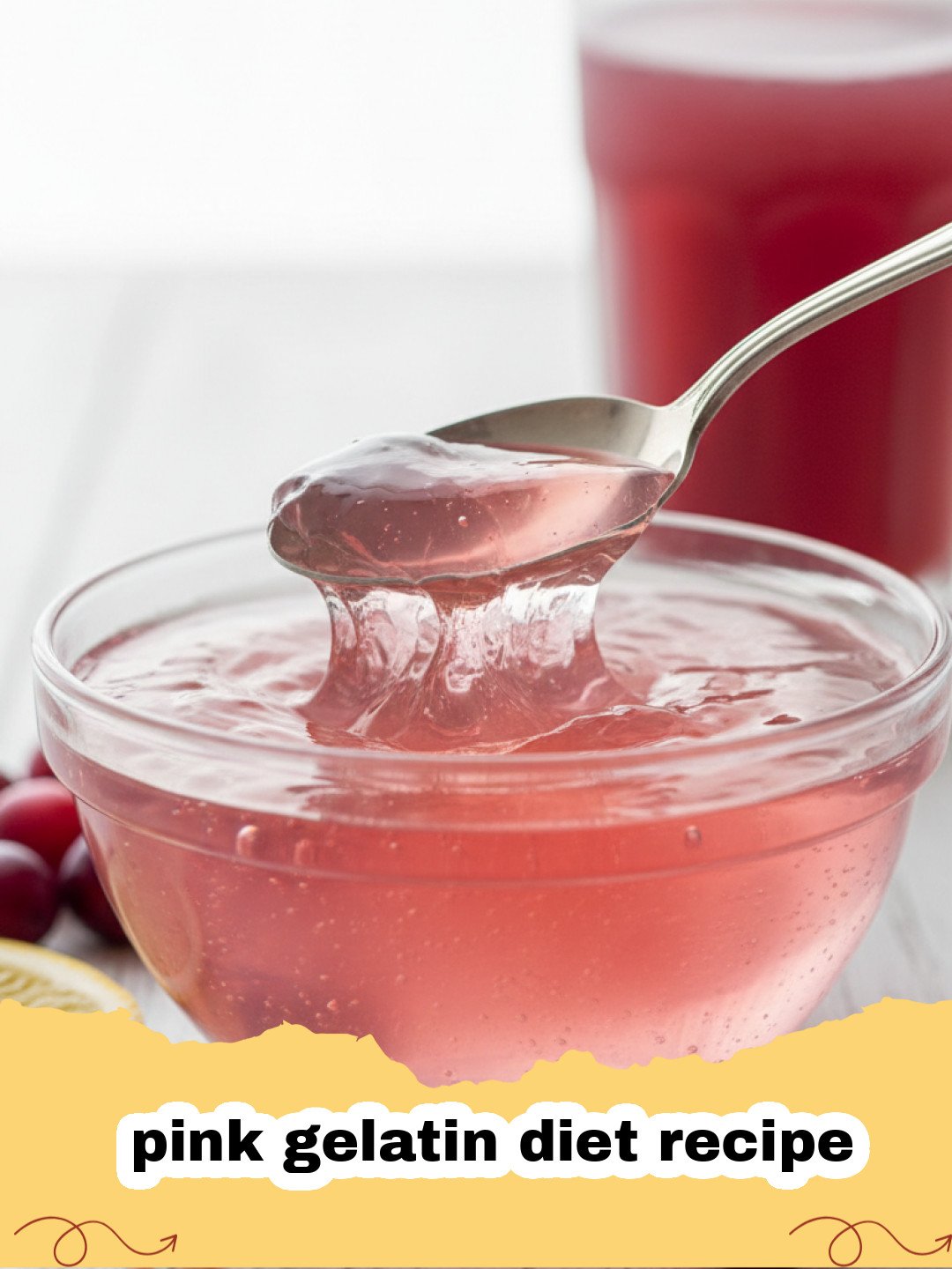 A shimmering bowl of pink gelatin diet recipe, garnished with fresh raspberries and mint.