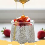 chia pudding recipe - Close-up of creamy chia pudding in a glass jar, topped with fresh berries, sliced almonds, and a drizzle of maple syrup, against a light background.