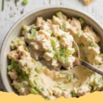 A close-up of the best chicken salad recipe homemade, served in a bowl with fresh parsley garnish.