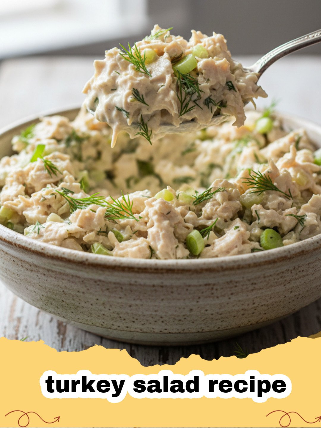 turkey salad recipe - A creamy classic turkey salad with celery and herbs, served in a bowl with crackers.