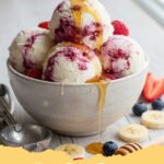 Scoop of creamy vanilla cottage cheese ice cream in a bowl with fresh berries