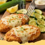 chicken and zucchini recipes - One-pan lemon herb chicken and zucchini on a baking sheet, garnished with fresh herbs