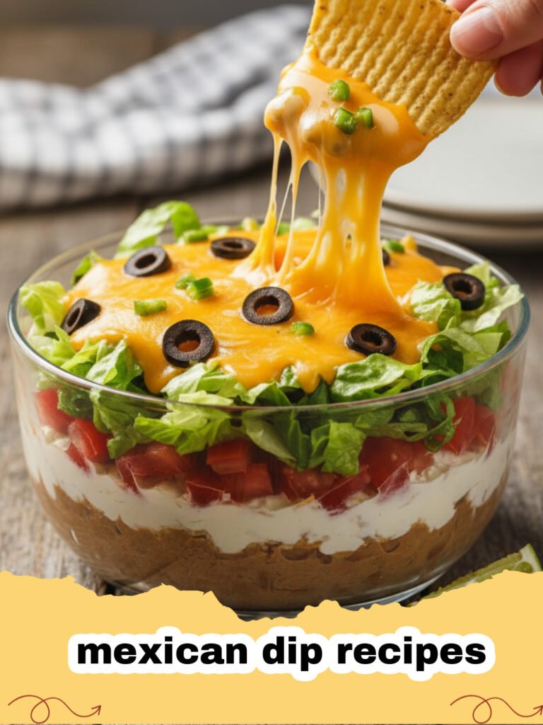 mexican dip recipes - Close-up of a bubbly, cheesy Fiesta Layered Bean & Cheese Dip topped with fresh cilantro, tomatoes, and green onions, with tortilla chips in the background.