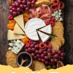 charcuterie board ideas - A beautifully arranged charcuterie board filled with a variety of cheeses, cured meats, fresh fruits, crackers, nuts, and jams.
