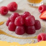 probiotic gummies recipe - Vibrant, homemade fruit-flavored probiotic gummies in various fun shapes, arranged on a white background with a few fresh berries, highlighting their natural and healthy appeal.