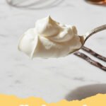 whipped cream recipe - Close-up of fluffy homemade whipped cream in a bowl with a whisk, ready to be served