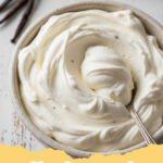 whipped cream recipe - A fluffy mound of homemade whipped cream in a glass bowl, with a whisk beside it, ready to be served.