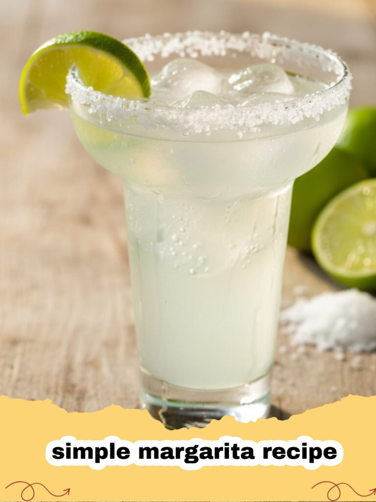 simple margarita recipe - A fresh simple margarita in a salt-rimmed glass with a lime garnish on a wooden table.