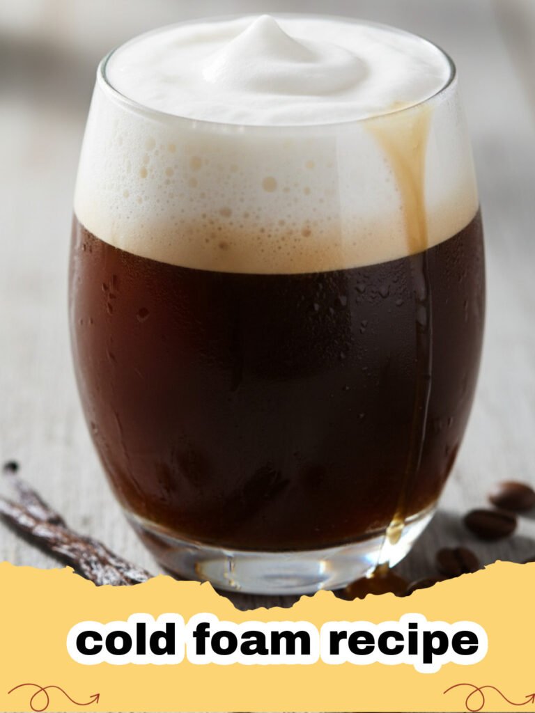cold foam recipe - A glass of iced coffee topped with fluffy vanilla cold foam and a straw.