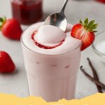 strawberry cold foam recipe - Iced coffee topped with fluffy pink strawberry cold foam and a fresh strawberry slice