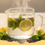 summer simmer pot recipes - A simmering pot filled with orange slices, lemon slices, rosemary sprigs, and cinnamon sticks, emitting steam and a fresh aroma.