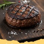 hamburger patties recipe - Close-up of a perfectly grilled, juicy hamburger patty on a bun with fresh toppings, ready to eat.