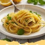 Close-up of vibrant lemon herb pasta in a bowl, garnished with fresh herbs and lemon wedges.