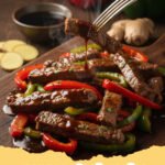 A vibrant skillet pepper steak recipe with tender beef, colorful bell peppers, and a rich brown sauce, served over white rice.