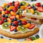 fruit pizza recipe - A vibrant and colorful classic fruit pizza on a white platter, adorned with fresh strawberries, blueberries, kiwi, and mandarin oranges.