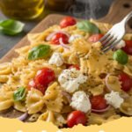 boursin cheese recipes - Creamy Boursin Pasta with Spinach and Sun-Dried Tomatoes in a bowl with a fork