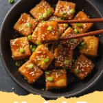tofu recipes healthy - Crispy glazed tofu cubes with bell peppers and green onions, served over rice.