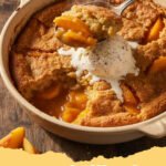 Warm easy peach cobbler recipe in a baking dish, with a scoop of vanilla ice cream melting on top.