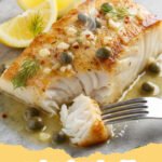 cod recipes healthy - Baked cod fillet with lemon and fresh herbs on a plate with roasted asparagus