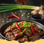 mongolian beef recipe - Close-up of homemade Mongolian beef served over white rice, garnished with green onions and sesame seeds