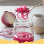 pickled onions recipe - Close-up of a glass jar filled with vibrant pink pickled red onions, with a few slices resting on a wooden board next to it.