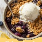 blueberry crisp recipe - A warm, golden-brown blueberry crisp in a baking dish, served with a scoop of vanilla ice cream.