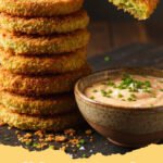fried green tomatoes recipe - A plate of crispy golden brown fried green tomatoes with a side of remoulade sauce.